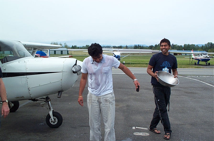 Manoj Shelke with Vinit Shinde after Manoj's successful Private Pilot Flight Test--a bit of nasty tradition.  Langley Flying School.